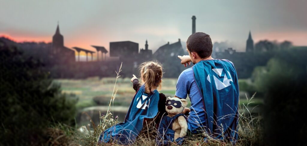little girl with dad dressed in super heroes, happy loving family